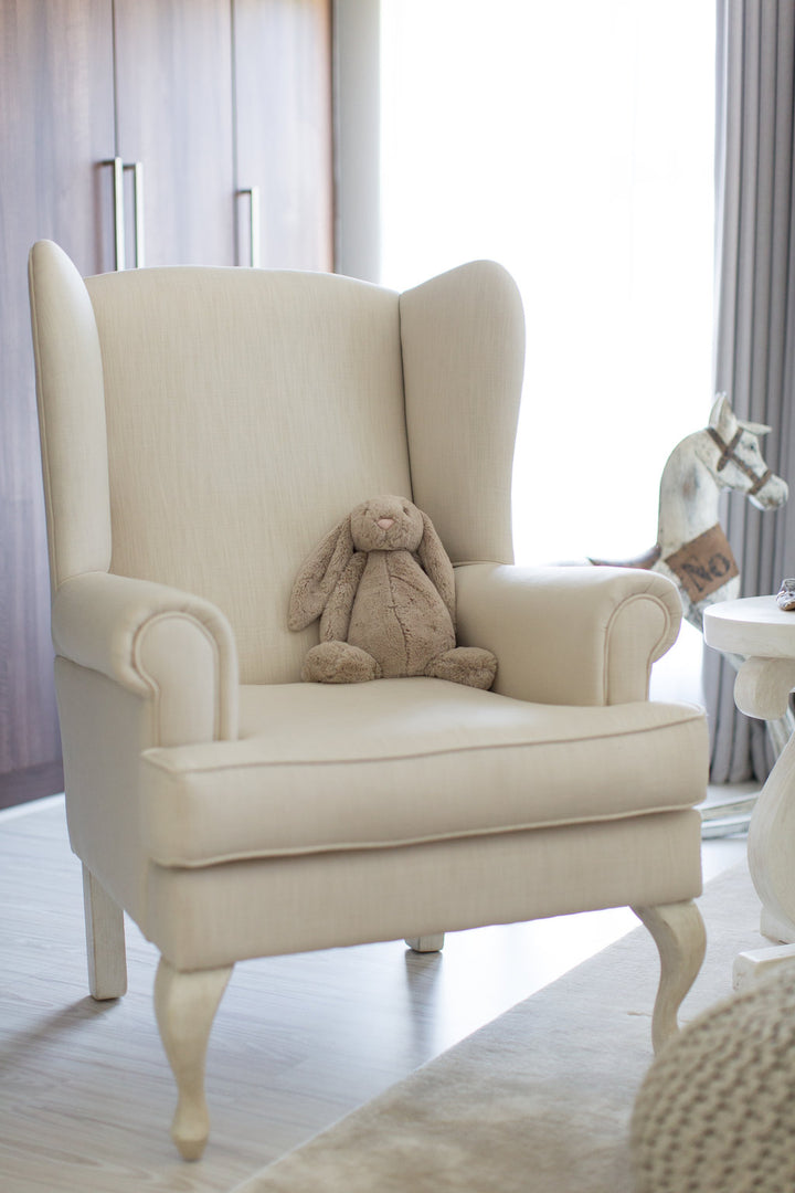 Baby Belle Oliver Feeding Chair in cream fabric with classic wingback design and Queen Anne legs, luxury nursing and feeding chair handcrafted in South Africa.