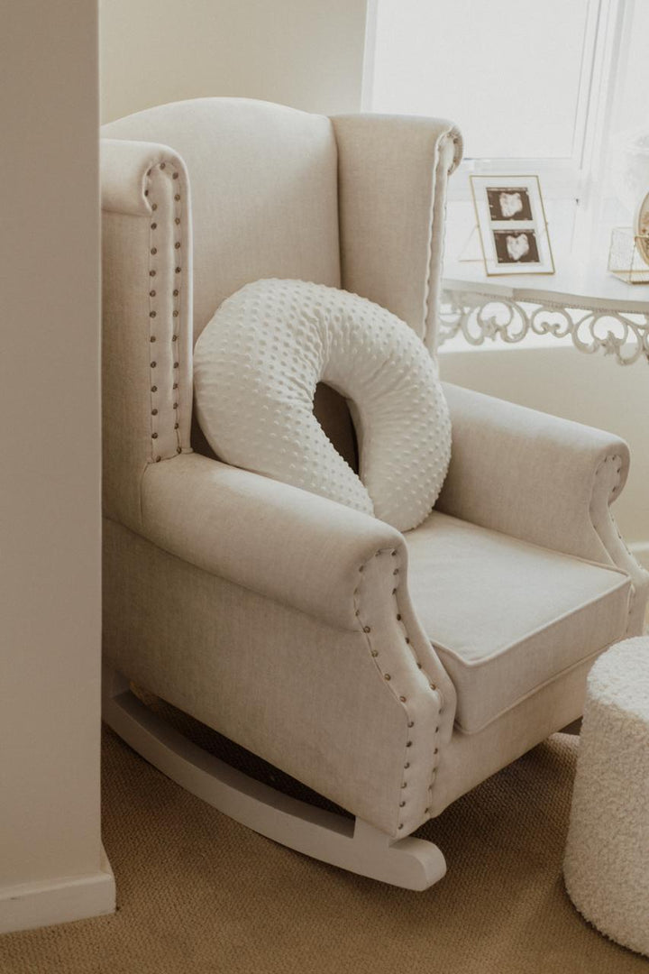 Baby Belle Romeo Rocking Chair in cream fabric with stud detailing and white painted wooden rocking legs, classic wingback nursing and feeding chair handcrafted in South Africa.