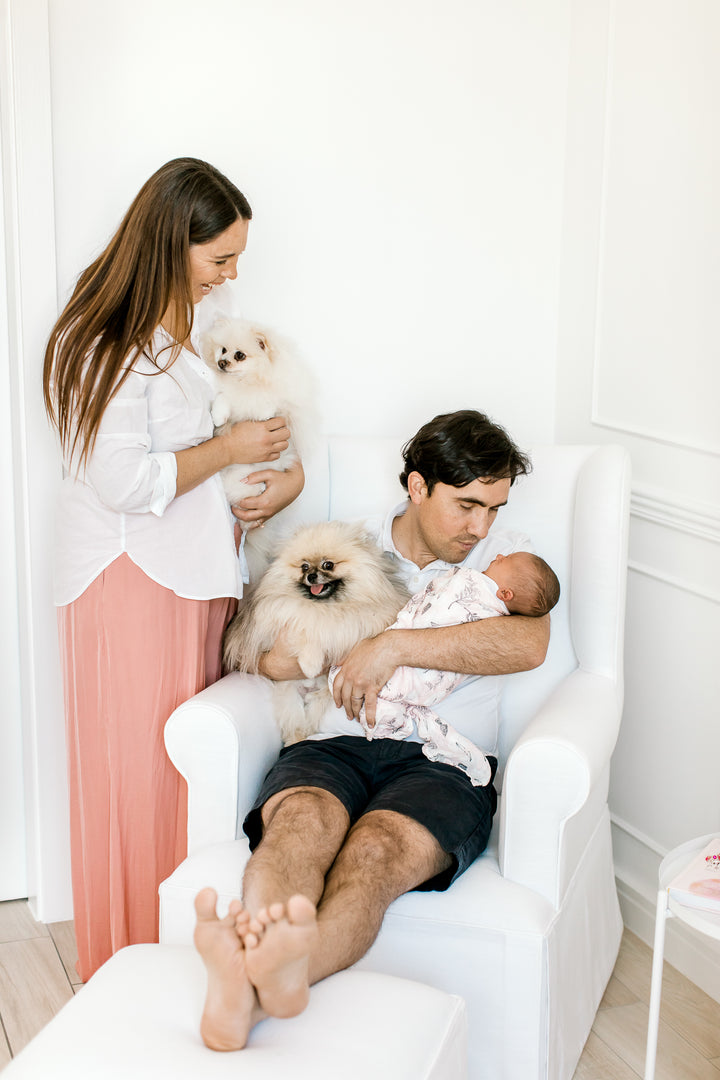 Family lifestyle photo featuring the Baby Belle Rose Feeding Chair with slipcover and ottoman, elegant wingback nursing chair with pleated skirt design, handcrafted in South Africa.